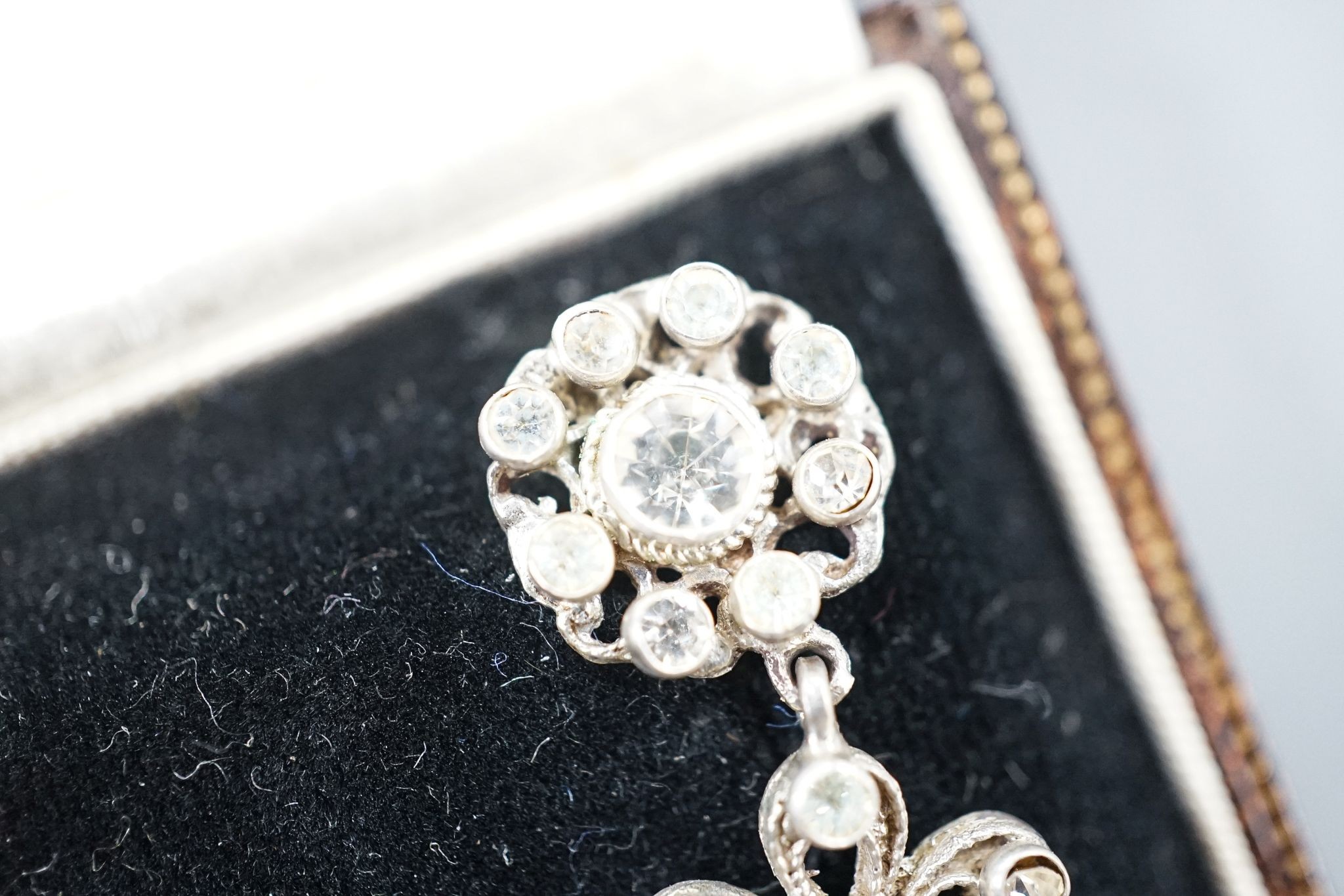 A pair of white metal and two colour paste drop earrings, 68mm, in a gilt tooled leather box.